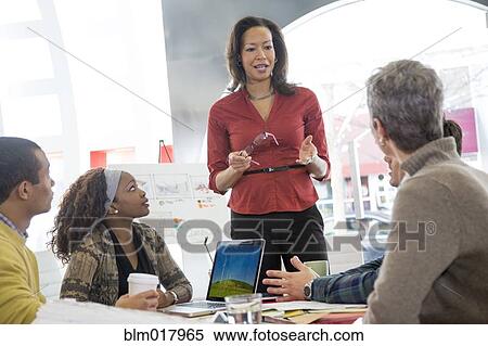 Stock Photography - Business people talking in meeting. Fotosearch