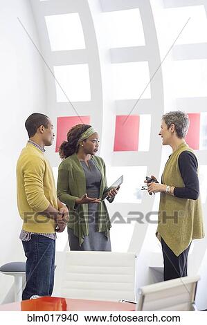 Business people talking in office View Large Photo Image Stock Image - Business people talking in office. Fotosearch