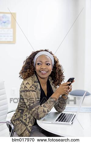 Stock Image - Business people talking in office. Fotosearch