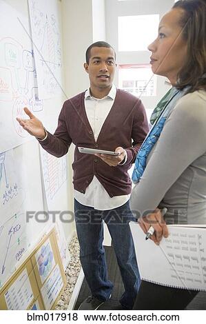 Business people talking in office View Large Photo Image Stock Photo - Business people talking in office. Fotosearch