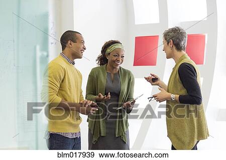 Business people talking in office View Large Photo Image Stock Photo - Business people talking in office. Fotosearch