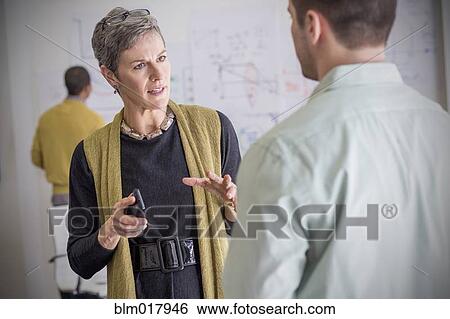 Business people talking in office View Large Photo Image Stock Photograph - Business people talking in office. Fotosearch