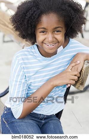 Cape Verdean girl smiling outdoors View Large Photo Image Stock Image - Cape Verdean girl smiling outdoors. Fotosearch