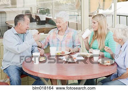 Picture - Caucasian family eating together. Fotosearch