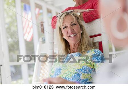 Caucasian woman sitting on porch View Large Photo Image Stock Image - Caucasian woman sitting on porch. Fotosearch