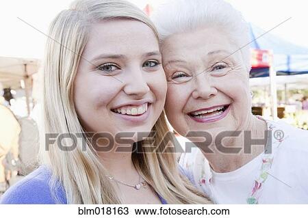 Stock Image - Caucasian woman smiling with granddaughter. Fotosearch