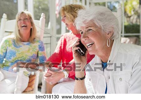 Stock Image - Caucasian woman talking on cell phone. Fotosearch