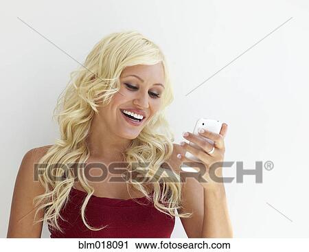Stock Image - Caucasian woman using cell phone. Fotosearch