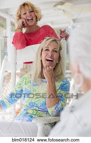 Picture - Caucasian women laughing together. Fotosearch