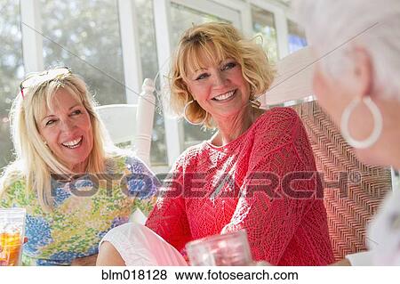 Caucasian women talking on porch View Large Photo Image Stock Photo - Caucasian women talking on porch. Fotosearch