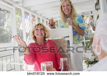 Caucasian women talking on porch View Large Photo Image Stock Photography - Caucasian women talking on porch. Fotosearch