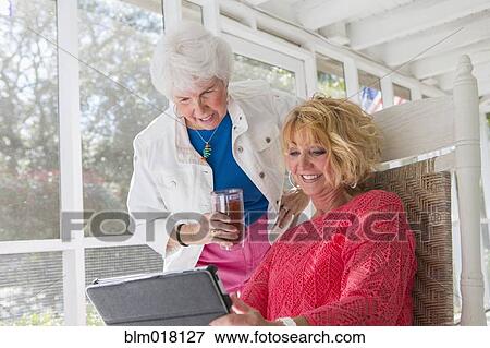 Caucasian women using tablet computer View Large Photo Image Stock Photo - Caucasian women using tablet computer. Fotosearch