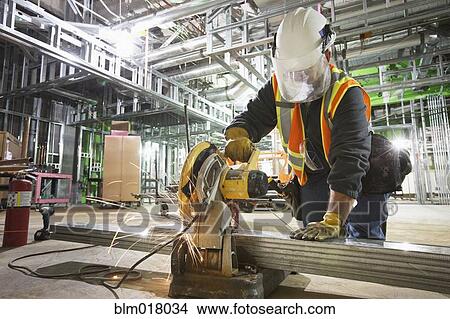 Caucasian worker cutting metal on site View Large Photo Image Picture - Caucasian worker cutting metal on site. Fotosearch