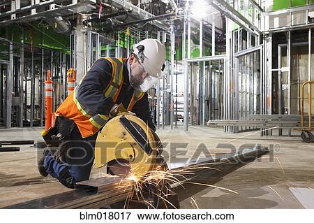 Caucasian worker cutting metal on site View Large Photo Image Stock Photo - Caucasian worker cutting metal on site. Fotosearch