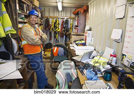 Stock Photo - Caucasian worker smiling in office on site. Fotosearch