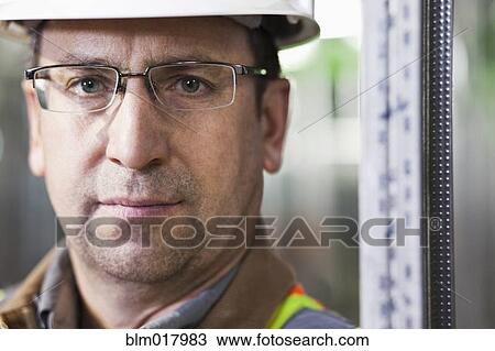 Stock Image - Close up of Caucasian worker's face. Fotosearch