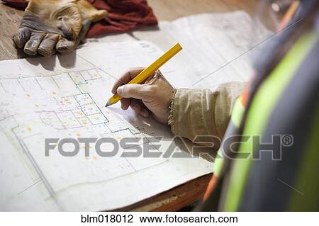 Construction worker marking blueprints View Large Photo Image Stock Image - Construction worker marking blueprints. Fotosearch