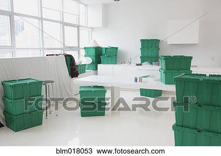 Stock Image - Green boxes in empty house. Fotosearch