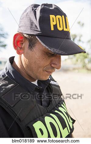 Stock Photo - Hispanic policeman outdoors. Fotosearch