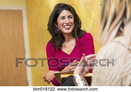 Hispanic women talking indoors View Large Photo Image Stock Image - Hispanic women talking indoors. Fotosearch