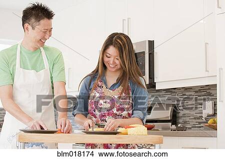 Japanese couple cooking in kitchen View Large Photo Image Picture - Japanese couple cooking in kitchen. Fotosearch