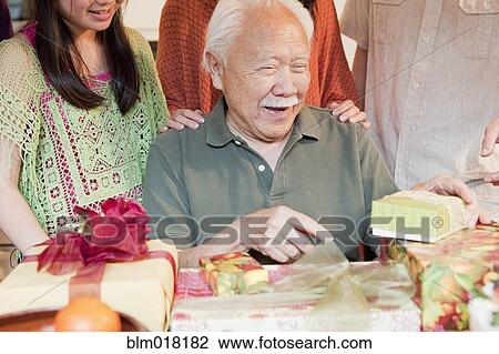 Stock Image - Japanese family celebrating birthday together. Fotosearch