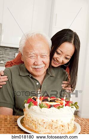 Stock Image - Japanese father and daughter celebrating birthday. Fotosearch