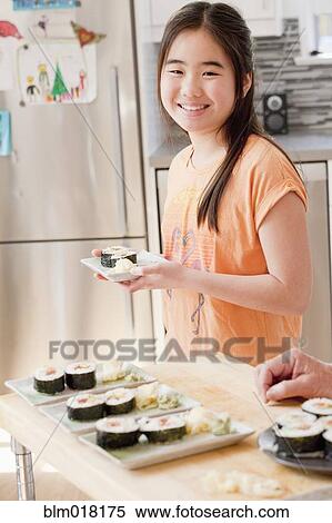 Japanese girl cooking in kitchen View Large Photo Image Stock Photography - Japanese girl cooking in kitchen. Fotosearch
