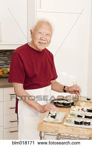 Japanese man cooking in kitchen View Large Photo Image Stock Image - Japanese man cooking in kitchen. Fotosearch
