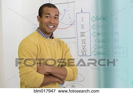 Stock Photo - Mixed race businessman smiling in office. Fotosearch