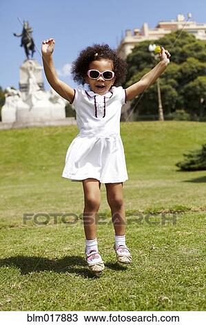 Mixed race girl playing in park View Large Photo Image Stock Image - Mixed race girl playing in park. Fotosearch