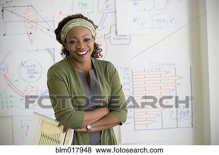 Stock Photo - Mixed race woman smiling in classroom. Fotosearch