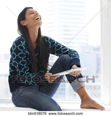Mixed race woman using tablet computer View Large Photo Image Stock Photo - Mixed race woman using tablet computer. Fotosearch