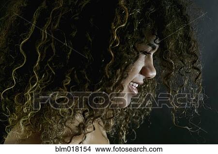 Picture - Mixed race woman with curly hair. Fotosearch