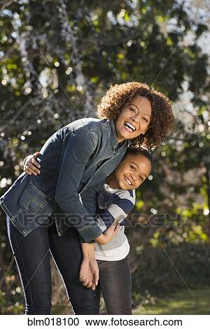 Stock Image - Mother and daughter smiling outdoors. Fotosearch