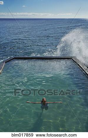 Pacific Islander woman floating in pool View Large Photo Image Stock Photo - Pacific Islander woman floating in pool. Fotosearch