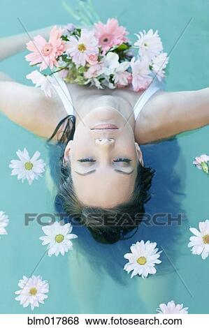 Pacific Islander woman holding flowers in pool View Large Photo Image Stock Photo - Pacific Islander woman holding flowers in pool. Fotosearch