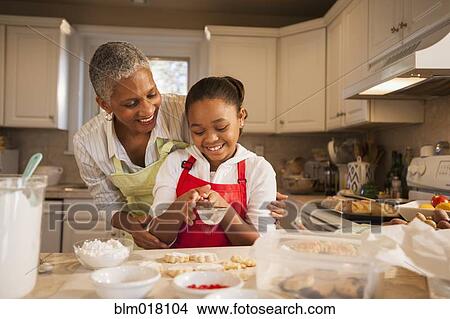 Picture - Woman and granddaughter baking in kitchen. Fotosearch
