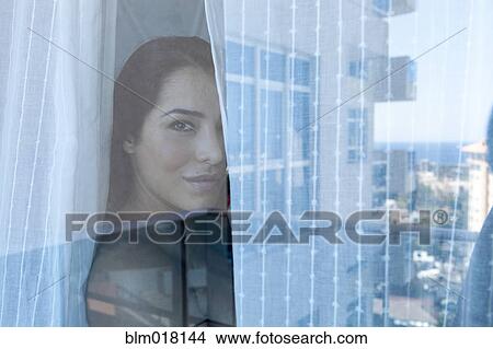 Woman looking out window View Large Photo Image Picture - Woman looking out window. Fotosearch