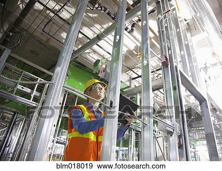 Worker using tablet computer on site View Large Photo Image Stock Photo - Worker using tablet computer on site. Fotosearch