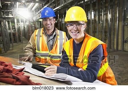 Stock Image - Workers smiling on site. Fotosearch