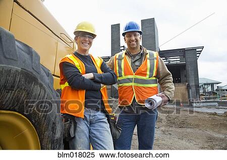 Stock Photography - Workers smiling on site. Fotosearch