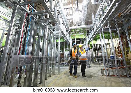 Stock Photo - Workers talking on site. Fotosearch