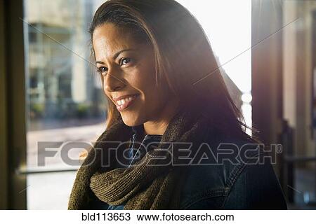 Stock Image - African American woman sitting in cafe. Fotosearch