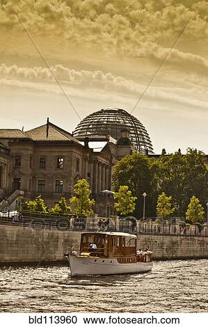 Boat sailing on urban canal, Berlin, Germany View Large Photo Image Stock Image - Boat sailing on urban canal, Berlin, Germany. Fotosearch
