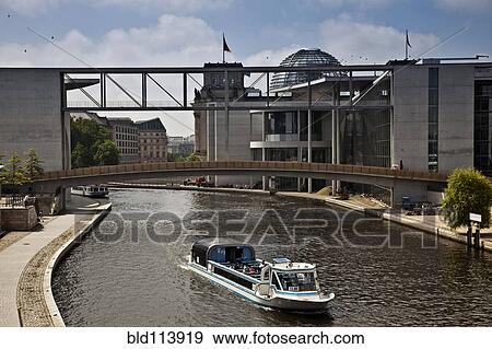 Boat sailing under bridge in urban canal, Berlin, Germany View Large Photo Image Stock Photo - Boat sailing under bridge in urban canal, Berlin, Germany. Fotosearch