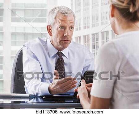 Stock Photograph - Caucasian businessman talking with client. Fotosearch
