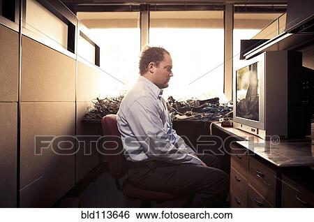 Caucasian businessman watching television at desk View Large Photo Image Stock Photograph - Caucasian businessman watching television at desk. Fotosearch