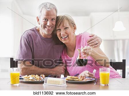 Caucasian couple having breakfast View Large Photo Image Stock Image - Caucasian couple having breakfast. Fotosearch