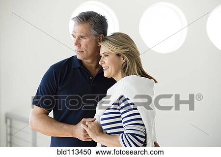 Stock Image - Caucasian couple holding hands . Fotosearch